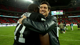 Menelik Watson hugs Vernon Kay