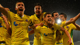 Neill Collins celebrates beating Fulham with his team-mates