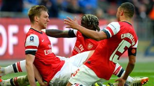 The Arsenal players celebrate Per Mertesacker's goal  