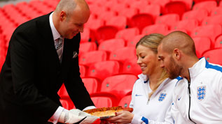 The Wembley butler delivers fans a hot dog
