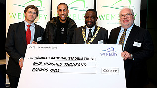 Wembley Managing Director Roger Maslin presents WNST Chairman Lord Toby Harris with a check for £900,000