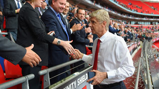 Arsene Wenger collects his Community Shield medal